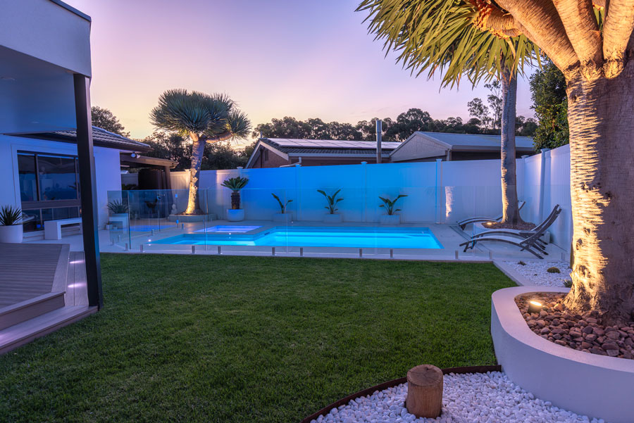 The Fibreglass Pool Company - Whitehaven style at dusk with lights